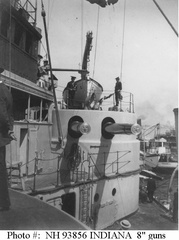 Crewmen standing atop her forward port side 8-inch gun turret, circa the later 1890s. The small steamer Riverside is visible on the right.