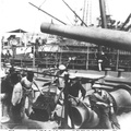 Crewmen loading small caliber fixed ammunition, 1898. The original photograph was published on a stereograph card by Webster & Albee, Rochester, NY.